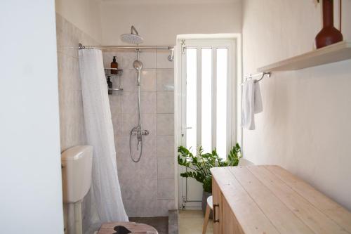 a bathroom with a shower and a wooden table at Daniela Village House in Keri