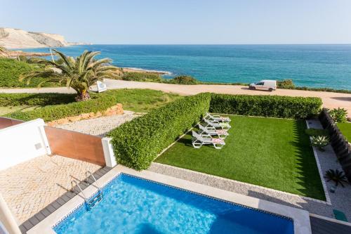 an aerial view of a resort with a swimming pool and the ocean at CoolHouses Algarve Luz, Ocean front 4 Bed house w/ pool, Casa da Pipa in Luz