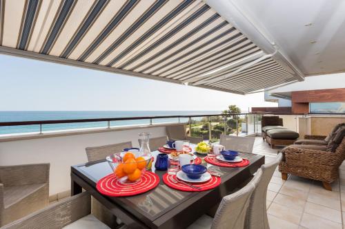 a dining room with a table with food on it at CoolHouses Algarve Luz, Ocean front 4 Bed house w/ pool, Casa da Pipa in Luz