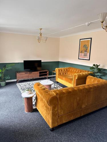 a living room with two couches and a television at 3BR Flat Sleeps 6 West End Sights Driveway in Glasgow