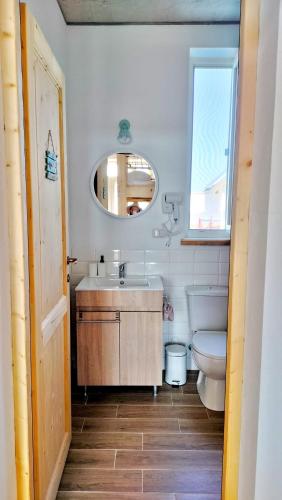 a bathroom with a sink and a toilet and a mirror at Wild Serenity in Vadu