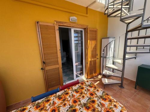 a view of a room with a bed and a staircase at Casa vista mare in San Nicola Arcella