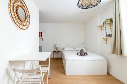 une petite chambre avec un lit et un bureau dans l'établissement Studio au coeur du panier, à Marseille