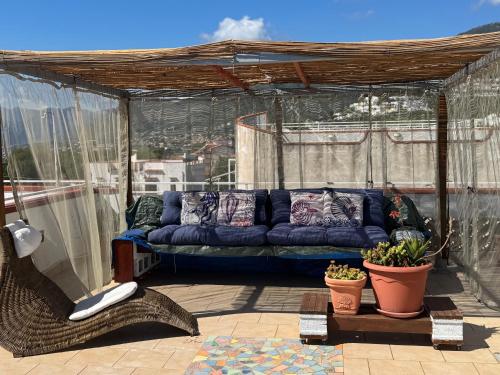 a blue couch sitting on top of a patio at Casa vista mare in San Nicola Arcella