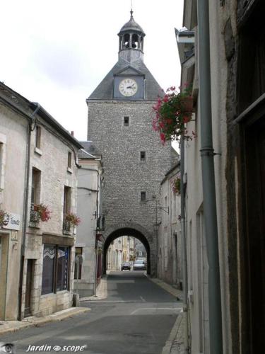 a building with a clock tower on top of it at Duplex de charme au coeur de Beaugency in Beaugency