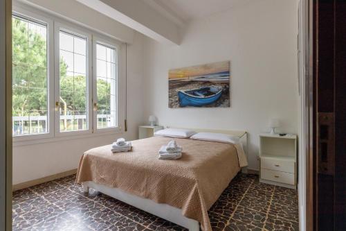 a bedroom with a bed with towels on it at Marina Dream 200 Meters From The Sea in Marina di Ravenna