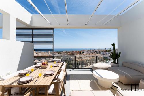 a dining room with a table and a view of the city at Luxury 3-Bed Mijas Villa, Sea View, Pool & Jacuzzi in Mijas