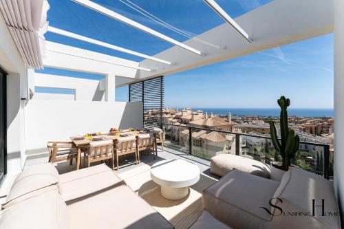 a living room with white furniture and a view of the city at Luxury 3-Bed Mijas Villa, Sea View, Pool & Jacuzzi in Mijas
