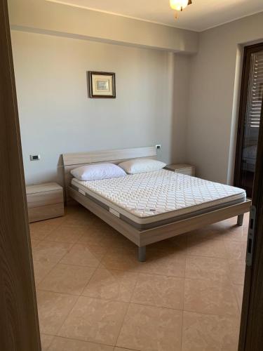 a bedroom with a bed in a room at Appartamento Fronte Mare Rosa 2 in Ardore Marina