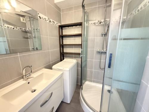 La salle de bains est pourvue d'un lavabo et d'une douche. dans l'établissement Sol-y-Days Fleurie 1 Appartement Grande Terrasse et Parking, à La Grande Motte