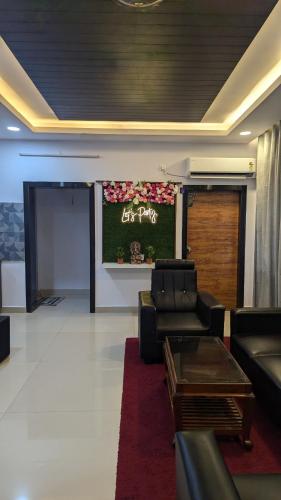 a living room with couches and a screen with an exit party at Rico Luxury Villa in Kākināda