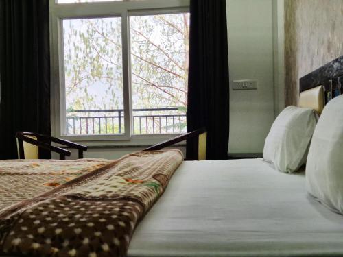 a bedroom with a bed with a large window at Hotel Lansdowne Vacations in Lansdowne