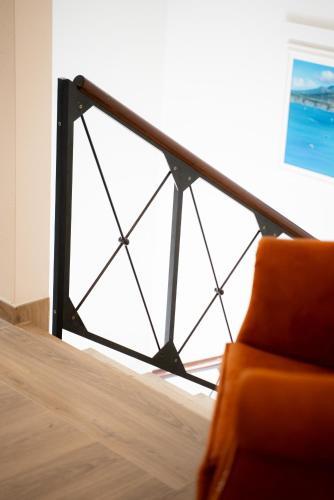 an orange chair in a room with a window at Locanda 19 al paradiso in Mirano