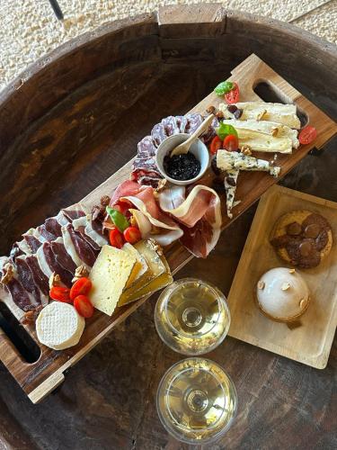 a tray of food with meats and cheese on a table at Le Rivalou - Chambres d'hôtes - Grazac - Tarn in Grazac