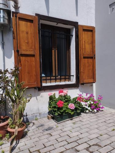 a window with flowers on the side of a building at Da Cocò in Udine