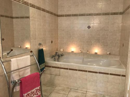 a bathroom with a tub with lights on it at Les petites chaumes in Champagné-le-Sec