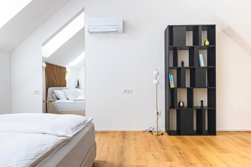 a bedroom with a bed and a book shelf at Vila Nina Bohinj in Bohinj
