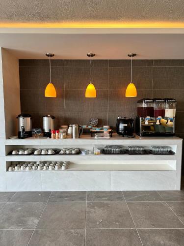 a kitchen with a counter with pots and pans at HOTEL DEL VALLE INN IXMIQUILPAN in Ixmiquilpan