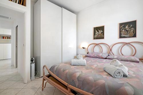 a bedroom with a large bed with towels on it at Relaxing Sea View in Lido di Jesolo