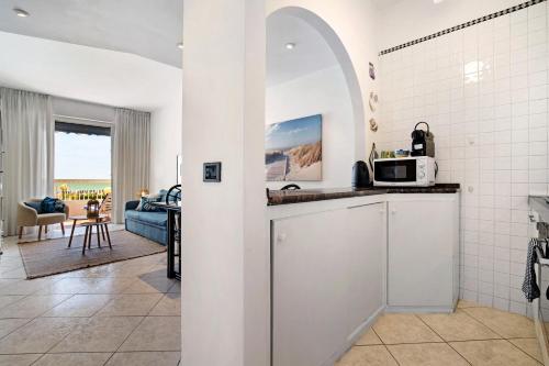 a kitchen with a counter with a microwave at Relaxing Sea View in Lido di Jesolo