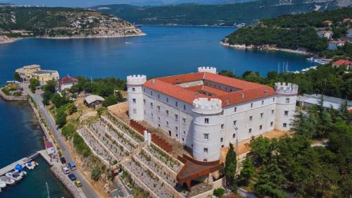 an aerial view of a large building on a lake at Kvarner View Rooms in Kraljevica