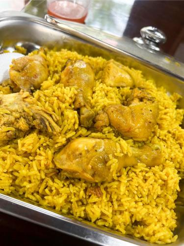 a tray of food with chicken and rice at Sun-San Thalane Resort in Ban Laem
