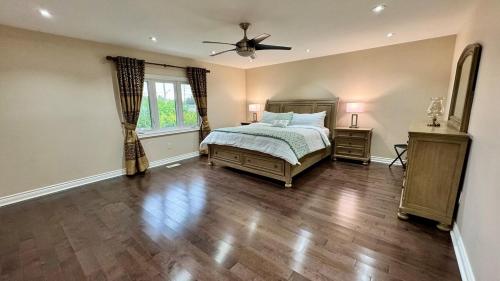a bedroom with a bed and a ceiling fan at Massive Luxury Retreat with Gym, Sauna, Games and More in Mississauga