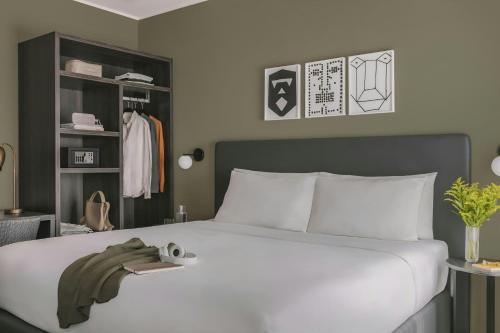 a bedroom with a large white bed and a closet at Missori Hotel Piazza Missori, Sonder by Marriott Bonvoy in Milan