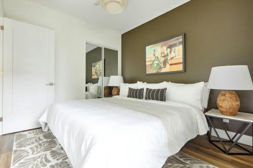 a bedroom with a large white bed and a lamp at Sonder by Marriott Bonvoy The Elm Apartments Downtown in Toronto