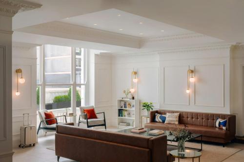 a living room with a couch and a table at The Henry Hotel Bayswater, Sonder by Marriott Bonvoy in London