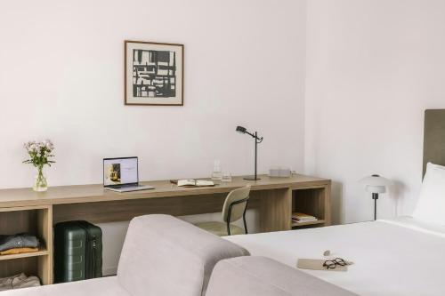 a bedroom with a desk and a bed and a desk and chair at Sonder by Marriott Bonvoy Atelier Apartments Porta Romana in Milan