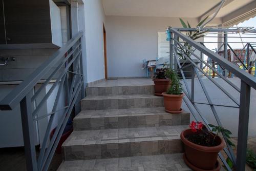 a set of stairs with potted plants on them at Dagos Rooms in Dhërmi