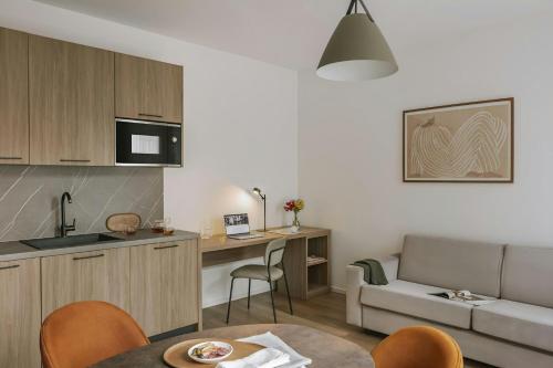 a kitchen and living room with a couch and a table at Sonder by Marriott Bonvoy Atelier Apartments Porta Romana in Milan
