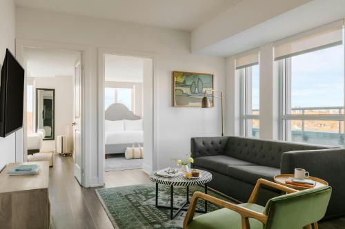 a living room with a couch and a bedroom at Sonder by Marriott Bonvoy Artesa Apartments West Queen West in Toronto