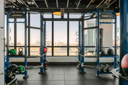 a gym with a view of the city at Sonder by Marriott Bonvoy Artesa Apartments West Queen West in Toronto
