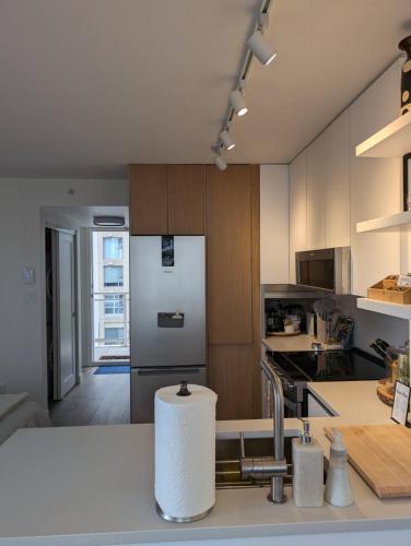 a kitchen with a roll of paper towels on a counter at Executive Studio in Vancouver