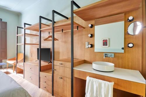 a bathroom with a sink and a mirror at Le Palacete Hotel Gracia District, Sonder by Marriott Bonvoy in Barcelona