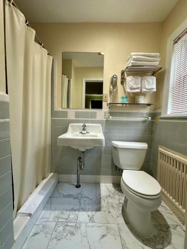 a bathroom with a toilet and a sink at Sea Girt Lodge in Sea Girt