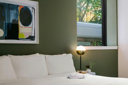 a bedroom with a white bed and a window at Sonder by Marriott Bonvoy Revival Apartments English Bay in Vancouver