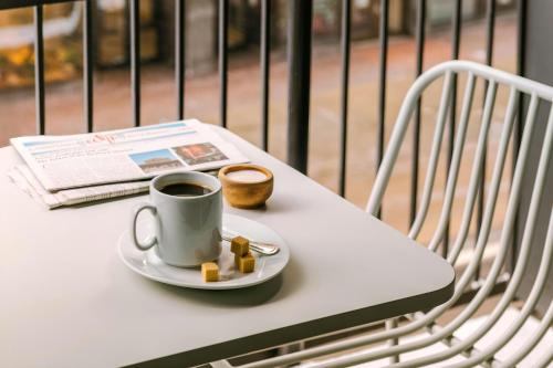 a cup of coffee and a plate of food on a table at Sonder by Marriott Bonvoy Arlo Apartments Downtown in Ottawa