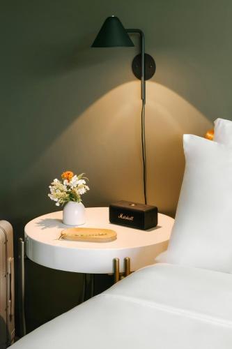 a bedside table with a lamp next to a bed at Sonder by Marriott Bonvoy Revival Apartments English Bay in Vancouver