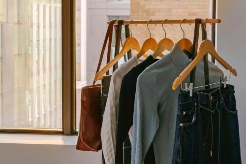 a bunch of clothes are hanging on a rack at Sonder by Marriott Bonvoy Arlo Apartments Downtown in Ottawa
