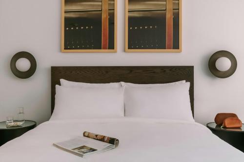 a bedroom with a bed with a book and two tables at Sonder by Marriott Bonvoy Arlo Apartments Downtown in Ottawa