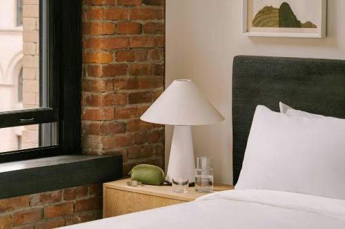 a bedroom with a bed and a lamp on a table at Sonder by Marriott Bonvoy Apollon Apartments Old Montreal in Montréal
