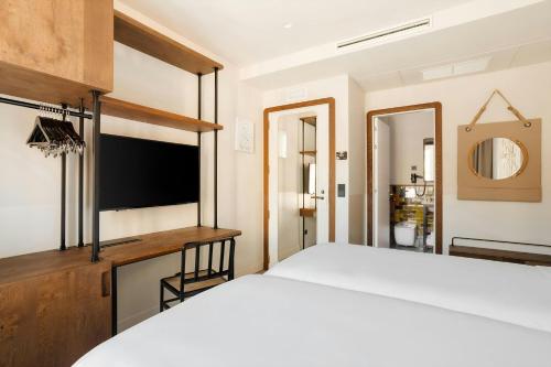 a bedroom with a large bed and a television at Casa Luz Hotel Plaça Universitat, Sonder by Marriott Bonvoy in Barcelona