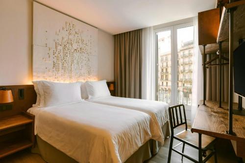 a hotel room with a bed and a window at Casa Luz Hotel Plaça Universitat, Sonder by Marriott Bonvoy in Barcelona
