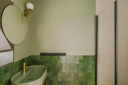 a bathroom with a sink and a mirror and a tub at Yelo Jean Médecin Hotel, Sonder by Marriott Bonvoy in Nice