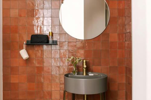 a bathroom with a sink and a mirror at Yelo Jean Médecin Hotel, Sonder by Marriott Bonvoy in Nice