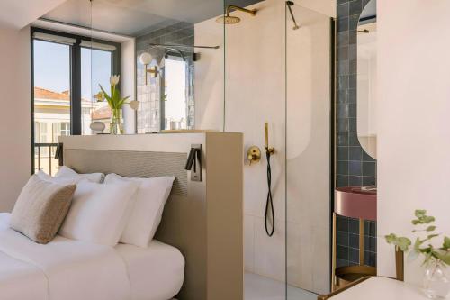 a bedroom with a white bed with white pillows at Yelo Jean Médecin Hotel, Sonder by Marriott Bonvoy in Nice