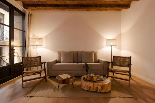 a living room with a couch and two chairs at Los Arcos Hotel Gothic Quarter, Sonder by Marriott Bonvoy in Barcelona